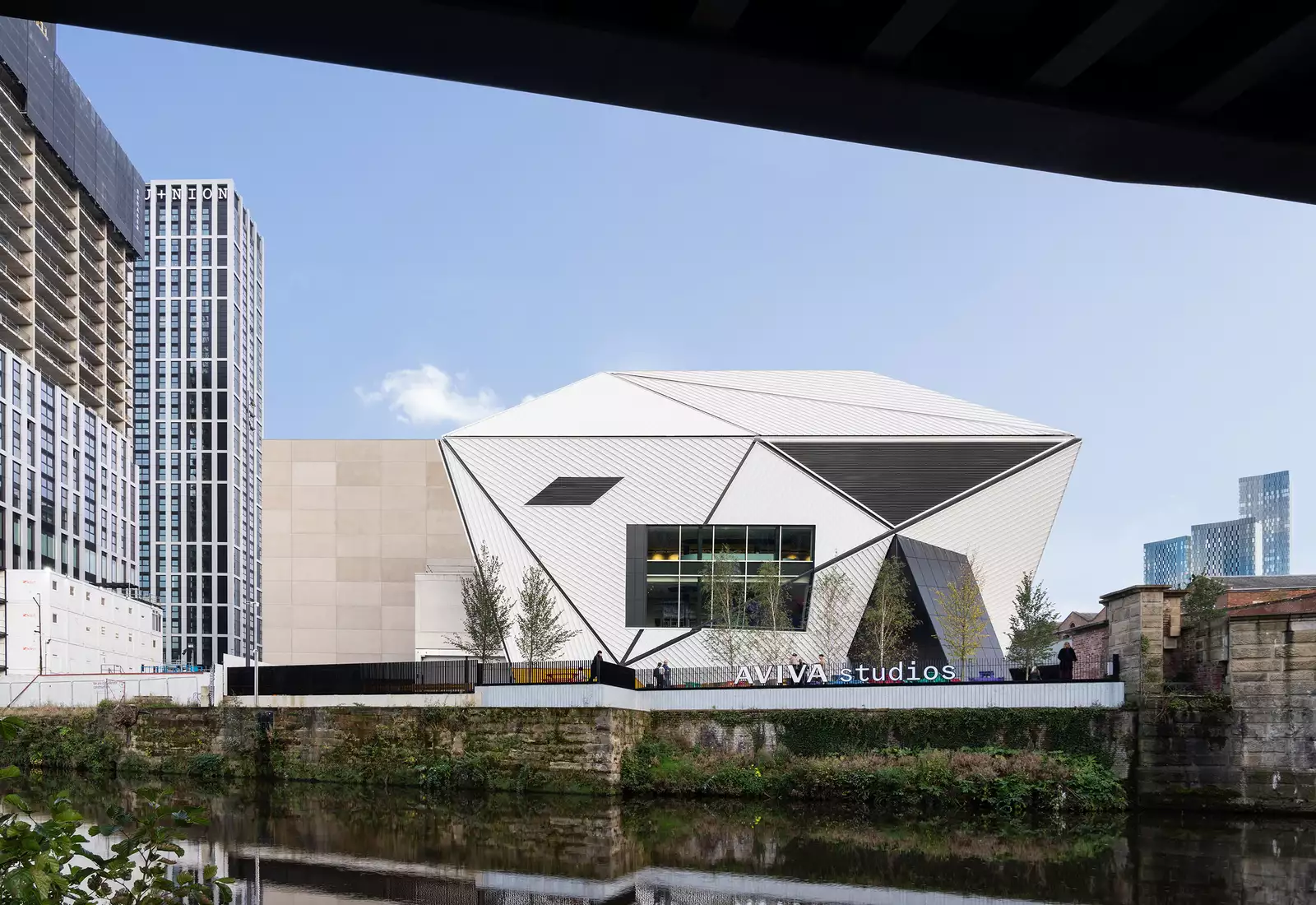 Photo of the exterior of Aviva Studios from across the river