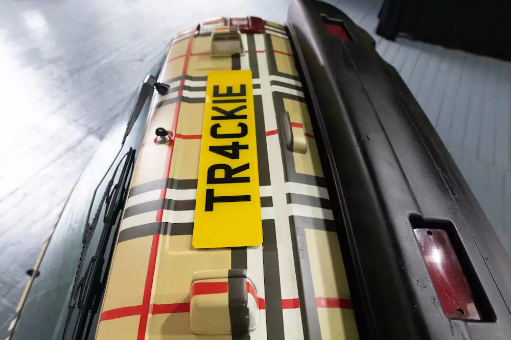 An artwork by Trackie McLeod showing the boot of a car with Burberry print and a number plate that reads 'TR4CKIE'
