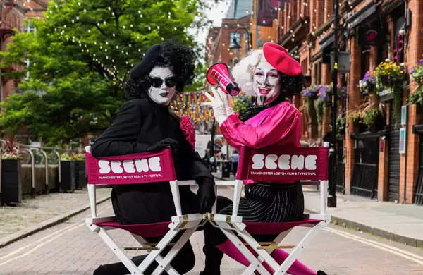 Two people sat on SCENE Festival branded chairs on Canal Street