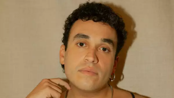 Close-up headshot of d.clemente on a beige background