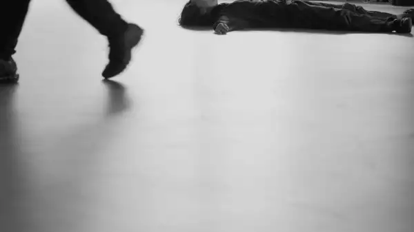 Black and white still from In the Studio with Blackhaine, showing a person lying on the floor