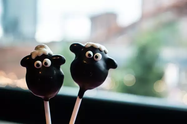 Two cake pops shaped like sheep